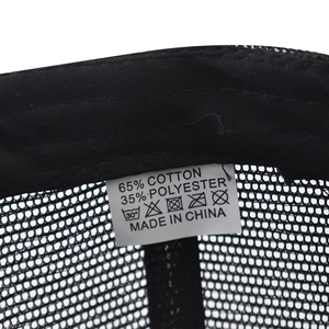 Macro detail of plaid baseball cap interior stitching and fabric composition label