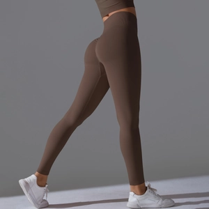 Detail view of high-waist seamless brown yoga pants focusing on the push-up butt lifting effect