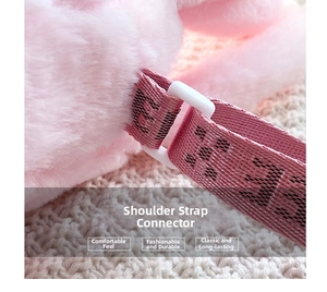 Detail of pink plush fabric bag with durable strap connection and lettered webbing strap