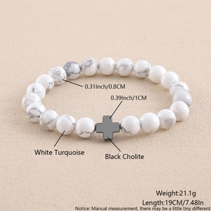 Detail view of white turquoise bead bracelet with black hematite cross and measurements