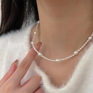 Elegant 925 sterling silver pearl necklace with baroque rice pearls on a soft white sweater