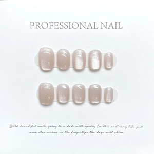 Pink cat-eye press-on nails set with glitter shimmer on white professional display card