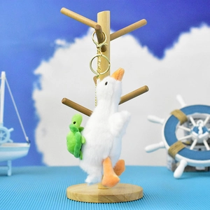 Adorable plush white goose keychain with a small green turtle on back for bags