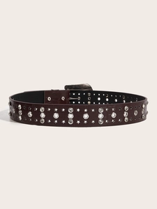 Detail of dark brown faux-crocodile belt featuring metallic star studs and rhinestones
