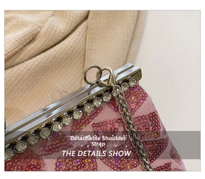 Detail showing the detachable metal chain strap with lobster clasp on pink sequin clutch bag