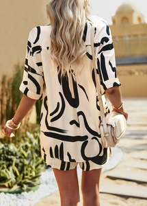 Rear view of woman in beige and black abstract print short sleeve shirt and shorts set