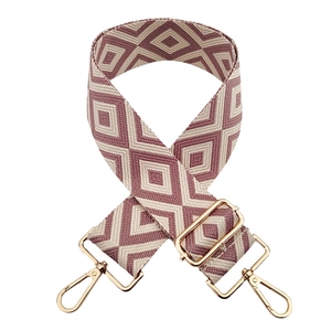 Close-up of pink diamond pattern jacquard strap with polished gold metal hardware