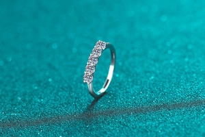 Close-up of five round-cut moissanite stones in a S925 sterling silver row ring setting