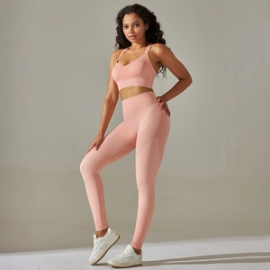 Detailed texture of seamless light pink yoga sports bra and high-waist leggings set