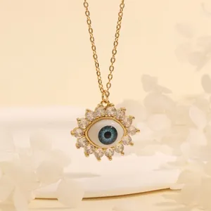 Macro shot of 18K gold plated evil eye pendant with blue enamel and white zircon stones