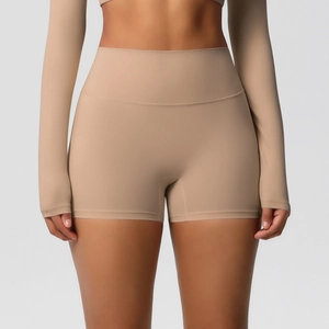 Detail view of high-waisted seamless tummy control yoga shorts in light brown