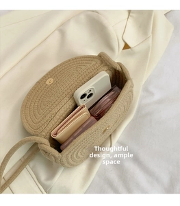 Detail shot of the spacious interior of a beige hand-woven shoulder bag with magnetic clasp
