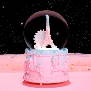 Pink carousel music box crystal ball with Eiffel Tower and ferris wheel inside