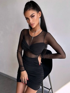 Detail view of black mesh patchwork sleeves and ruched V-neckline on a sexy bodycon dress