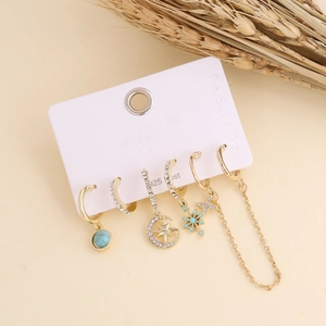 Macro detail of bohemian gold earrings set with turquoise beads and 925 silver posts