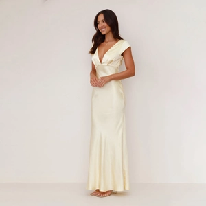 Close-up of elegant deep V-neck and silky satin texture on this slim fit evening gown