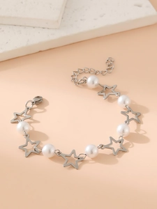 Detail of star pendants and white pearls on a silver stainless steel link bracelet
