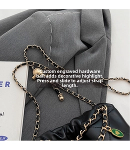 Detail of adjustable golden metal ball on quilted leather chain bucket bag