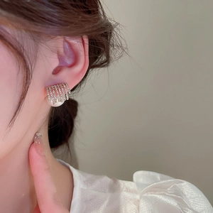 Elegant gold geometric earrings with pavé diamonds and a large lustrous white pearl drop