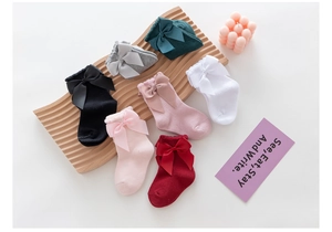 Detail of baby girl lolita socks showing large satin bows in seven assorted colors