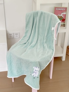 Detail of mint green lamb embroidered bath towel with soft plush fabric and woven edges