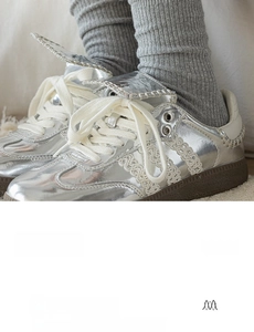 Close-up of gray combed cotton ribbed socks paired with metallic silver sneakers