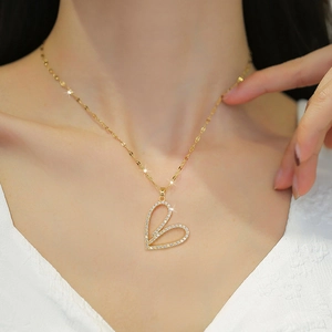 Luxurious gold heart pendant necklace with shimmering crystals on an elegant chain
