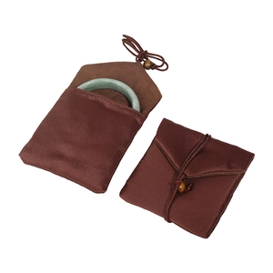 Deep brown silk jewelry pouches for bracelets with wooden bead drawstring on white background