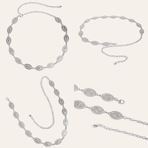 Close-up of vintage silver metal waist chain with embossed oval plates and lobster clasp