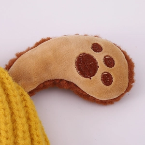 Detail of yellow knit winter hat featuring puppy ear texture and soft fleece trim