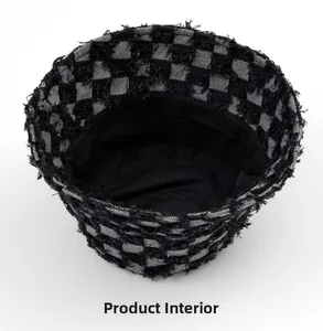 Detailed view of internal black lining and checkerboard pattern on frayed bucket hat