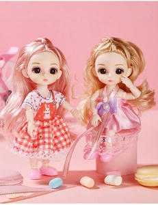 Detail of BJD style dolls with pink and blonde hair in lace and plaid dresses