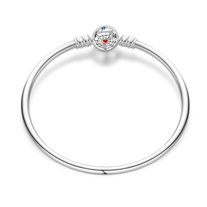 Detail of silver bracelet with spider web charm, red heart and Valiantly engraving