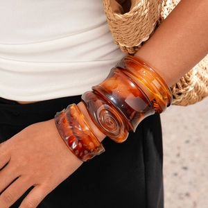 Vintage amber resin bangles with tortoiseshell patterns and irregular geometric designs