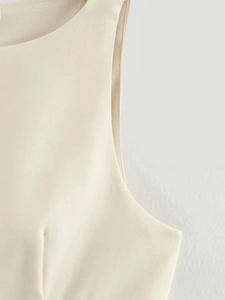 Detailed view of beige sleeveless dress featuring premium woven fabric and clean stitching