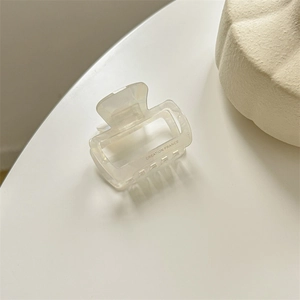 Detail view of the cream acetate square hair claw with Creation France engraving