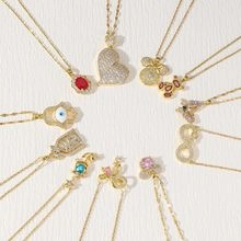 Detailed flat lay of gold necklaces featuring various colorful pendants and charms