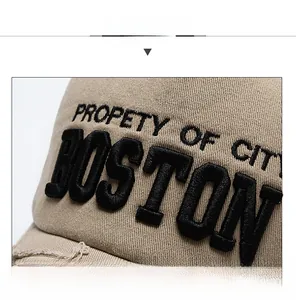 Detail of khaki denim baseball cap with 3D BOSTON embroidery and distressed brim edges