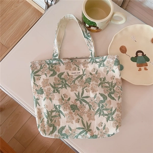 Detail of floral canvas tote bag with simple wish tag and soft vintage patterns
