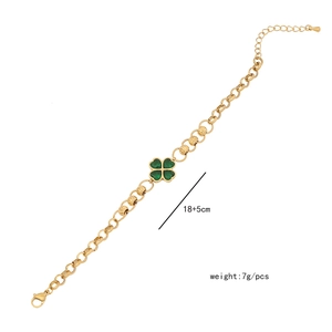Detailed view of golden clover bracelet with emerald green inlay and sizing specifications