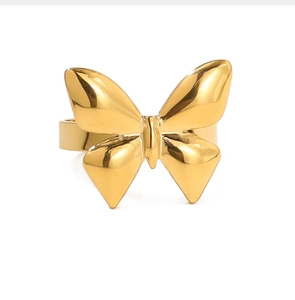 Detailed close-up showing the golden polished finish and texture of the bow-shaped ring