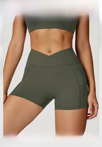 Detail of high-waist yoga shorts with V-cross waistband and side pocket in olive green