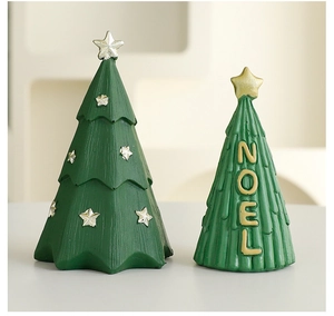 Close-up of green resin Christmas trees with gold NOEL lettering and star details