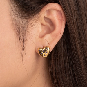 Elegant gold heart earrings with blue star-shaped gemstones on model for daily style