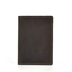 Macro view of dark brown crazy horse leather wallet featuring durable orange stitching