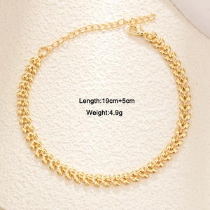 Golden double-layer wheat leaf chain bracelet with emerald zircon heart charm detail