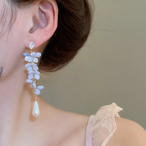 Detail of light blue petal tassel earrings with water drop pearl and sparkling zircon stud