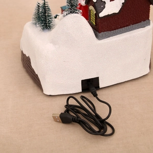 USB power cable detail on the back of a festive Christmas village decoration house