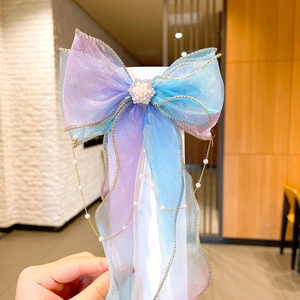 Detail of blue purple gradient tulle hair bow clip with star rhinestone and pearl tassels