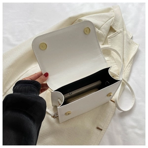 Internal view showing mobile phone and lipstick inside the white PU leather crossbody bag